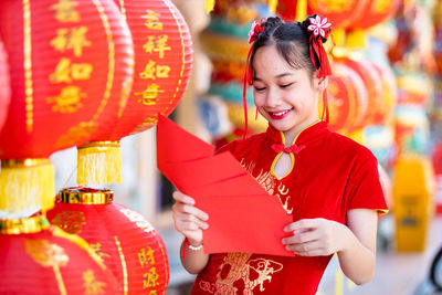 Young woman holding red umbrella