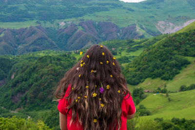 Rear view of woman walking on landscape