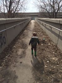 Full length of woman walking on footpath