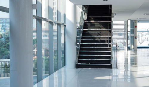 Staircase of modern building with sunlight through glass facade