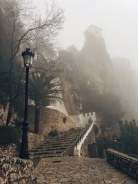 Steps leading towards mountain against sky