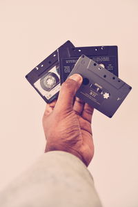 Close-up of man photographing against gray background