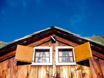 Low angle view of old building against blue sky