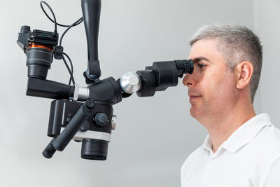 Side view of man holding camera