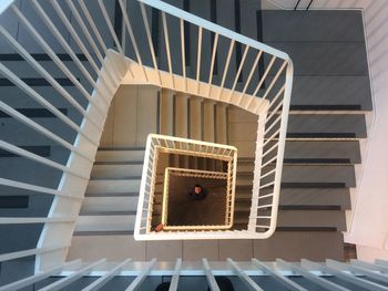 High angle view of man standing by spiral staircase