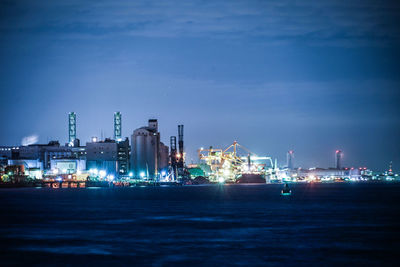 Boats in sea against sky at night