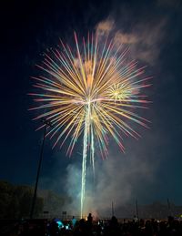 Low angle view of firework display at night