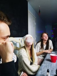 Happy young woman sitting at home