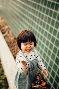 Portrait of smiling girl standing outdoors