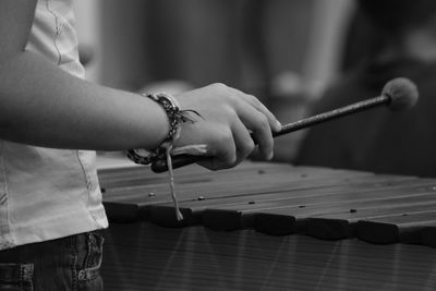 Midsection of person playing vibraphone