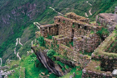 Stone walls from houses and road in the ancient inca city of machu picchu, in peru.