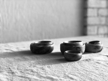 Close-up of objects on table against wall