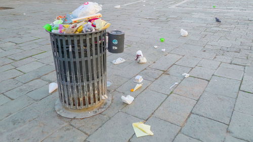 High angle view of garbage bin on sidewalk
