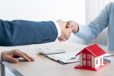 Cropped hands of doctor explaining to customer in office