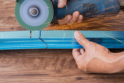 Cropped hand of man working in factory