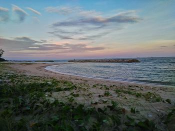 Scenic view of beach against sky during sunset