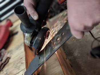 Midsection of person working on wood