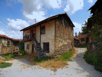 Footpath amidst buildings against sky in city