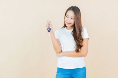Portrait of a smiling young woman against white background