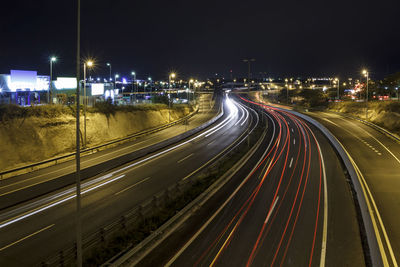 Long exposure shot of highway at night, with cars driving in the road