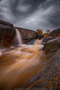 Scenic view of waterfall against sky