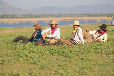 People relaxing on field