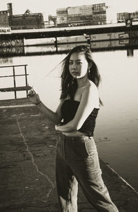 Full length of young woman standing on road