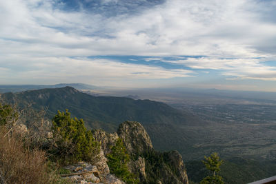 Scenic view of mountains against cloudy sky