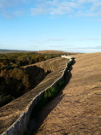 Scenic view of sand dunes against sky