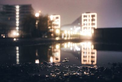 Reflection of illuminated buildings in river at night