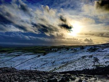 Scenic view of landscape against cloudy sky