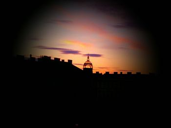 Silhouette city against sky during sunset