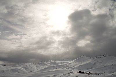 Scenic view of snow covered mountains against sky