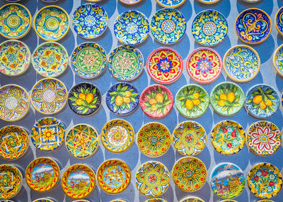 Directly above shot of colorful plates for sale at market stall