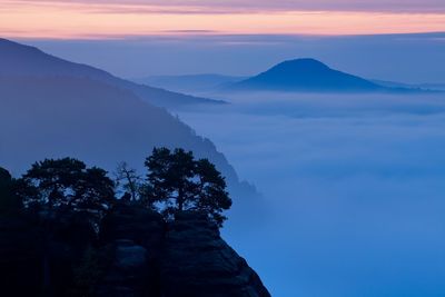 Scenic view of silhouette mountains against sky at sunset