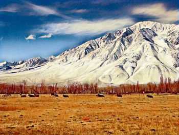 Scenic view of snowcapped mountains against sky