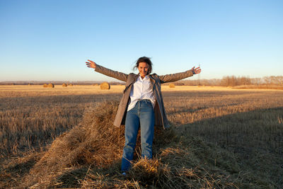 Full length of man standing on field against sky