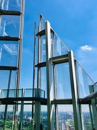 Low angle view of modern bridge against blue sky