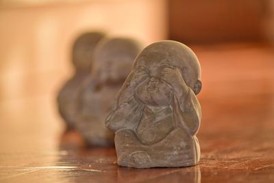 Close-up of buddha statue on table