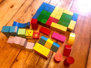 High angle view of multi colored toy blocks on wooden table