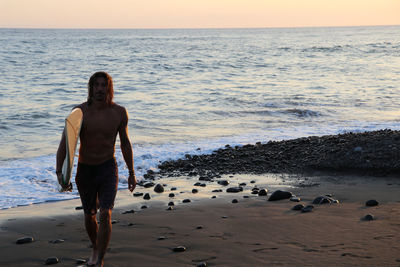 Full length of man standing on beach