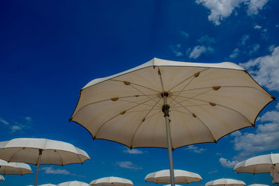White umbrellas open on a beautiful sunny day