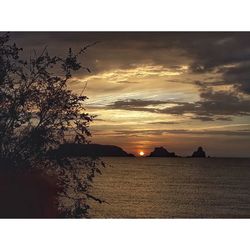 Scenic view of sea against sky at sunset