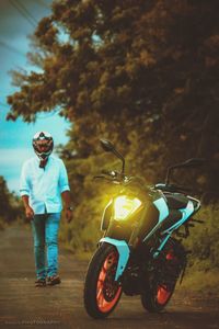 Young man riding motorcycle on road