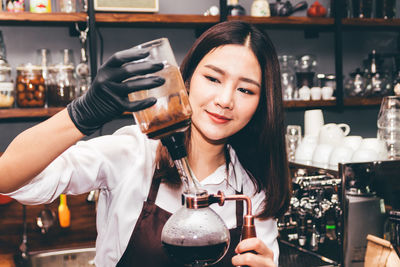 Portrait of smiling young woman holding ice cream