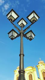 Low angle view of statue against blue sky