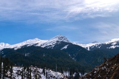 Scenic view of snowcapped mountains against sky