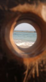 Close-up of sea seen through hole