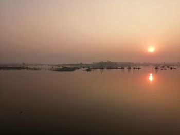 Scenic view of lake against sky during sunset