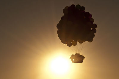 Low angle view of silhouette hot air balloon against sky during sunset